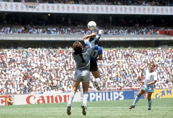 Argentina's Diego Maradona scores his side's first goal past English goalkeeper Peter Shilton by use of his hand, Maradona later claimed that the goal was scored by "The Hand Of God,"
